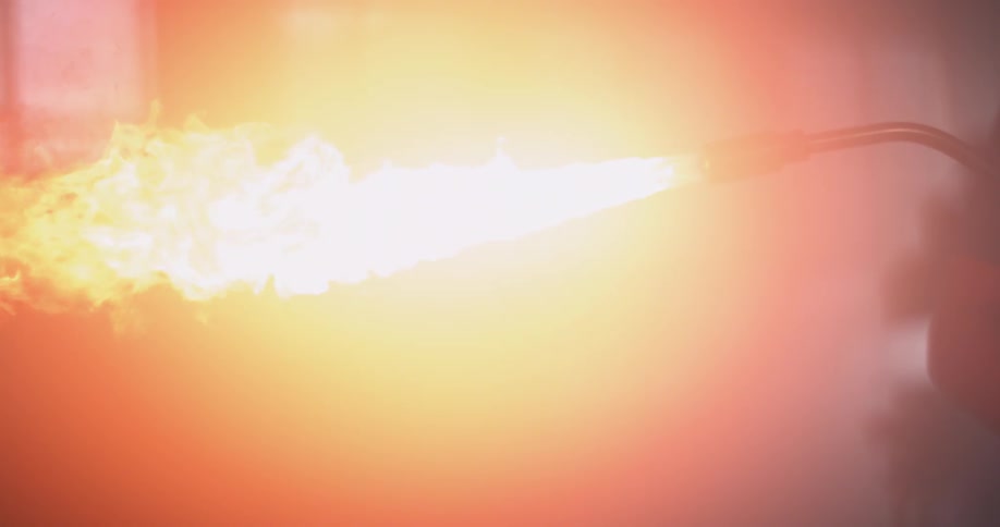 The flame of a blowtorch glows as it stretches across the air