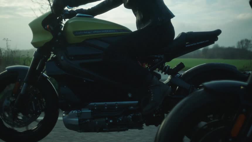 Bikers with black helmets jacket and pants ride motorcycles on highway