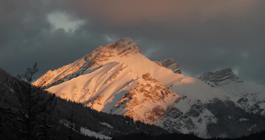 Dark storm clouds moving over a mountain range
