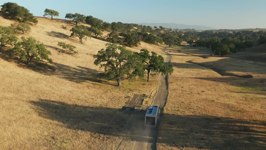 A van is driving down the trail