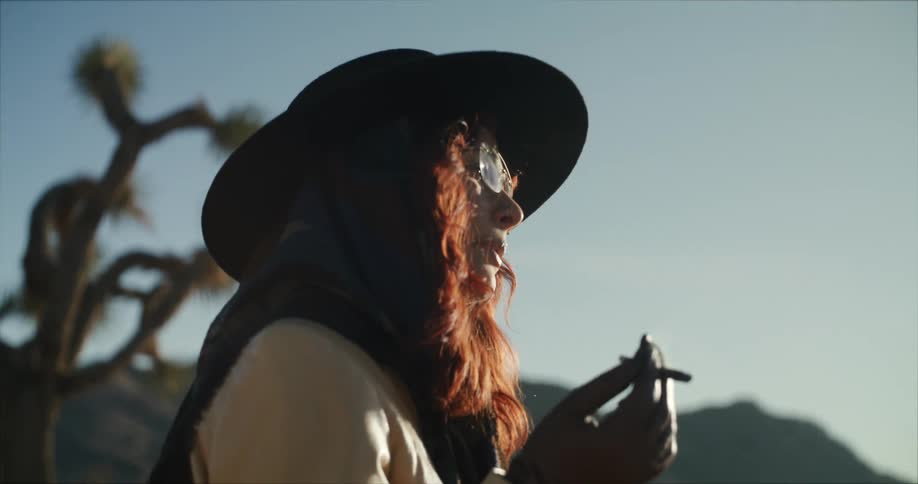 A woman is smoking on the field