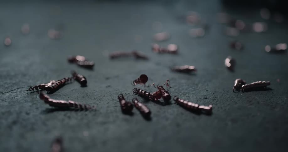 Metal shavings are falling and bouncing when they hit the floor