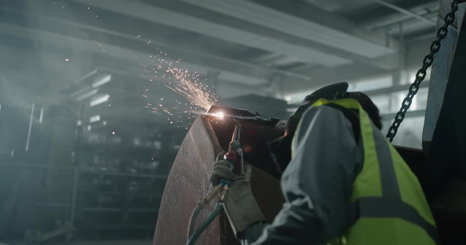 A welder welding metal in a shop