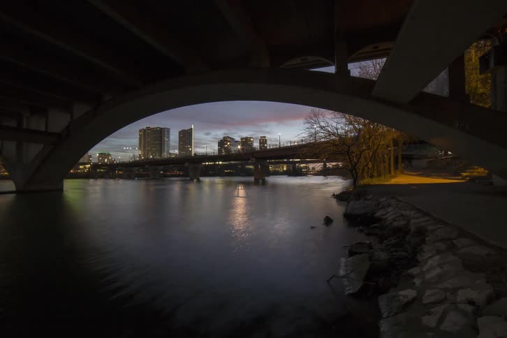 Water under a bridge as the sun rises