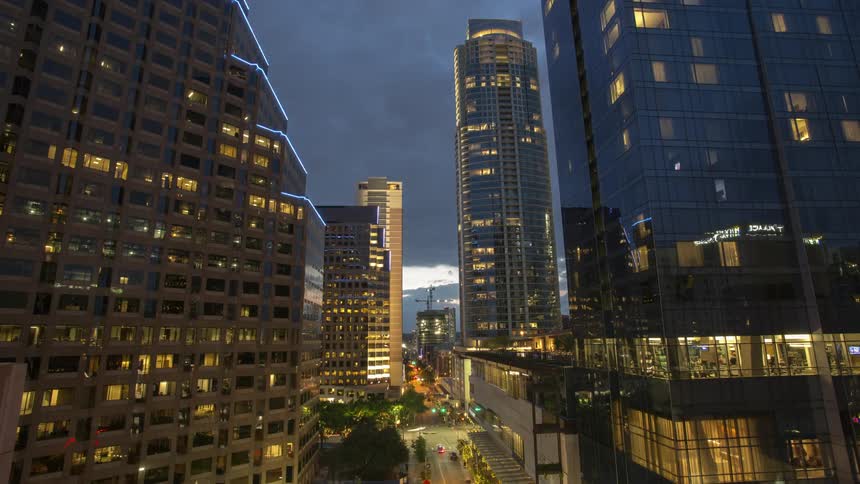 Vehicles travel below in this city with tall buildings