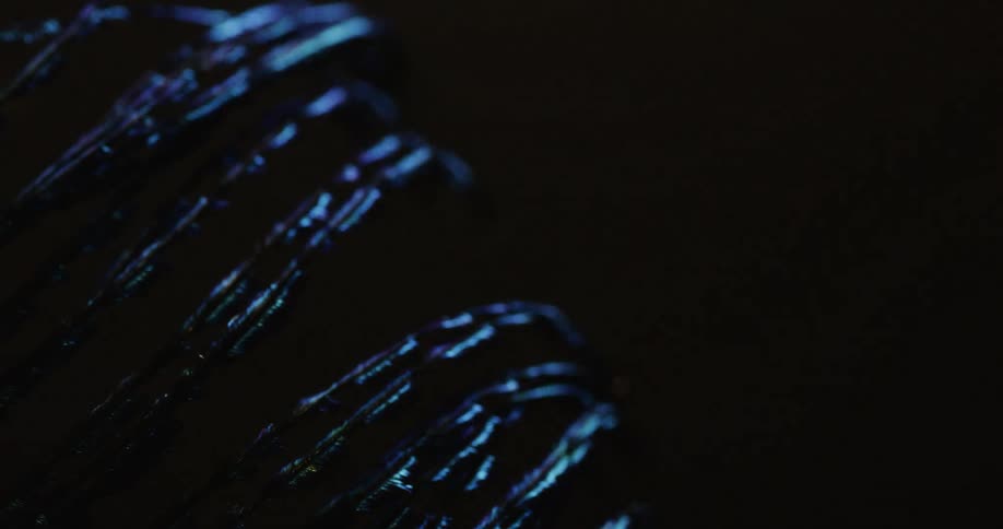 A light moves over a line of textured wires