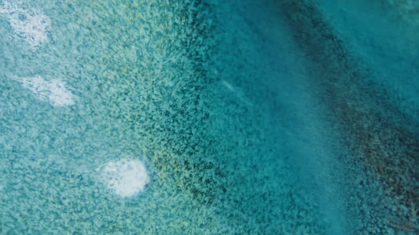 A clear liquid moves over a gray surface