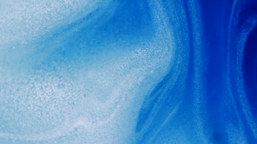 Layers in white and blues swirl through a mixture