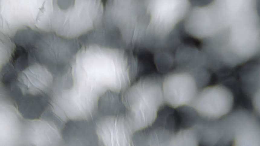 A translucent lightly textured layer moves over illuminated objects and lights