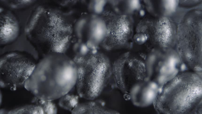 Silver blobs shift in their floating cluster