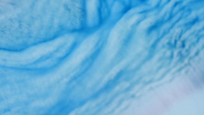 Swirls of blue foam moving around