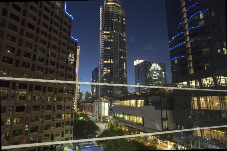 Traffic passing through a downtown intersection as night falls