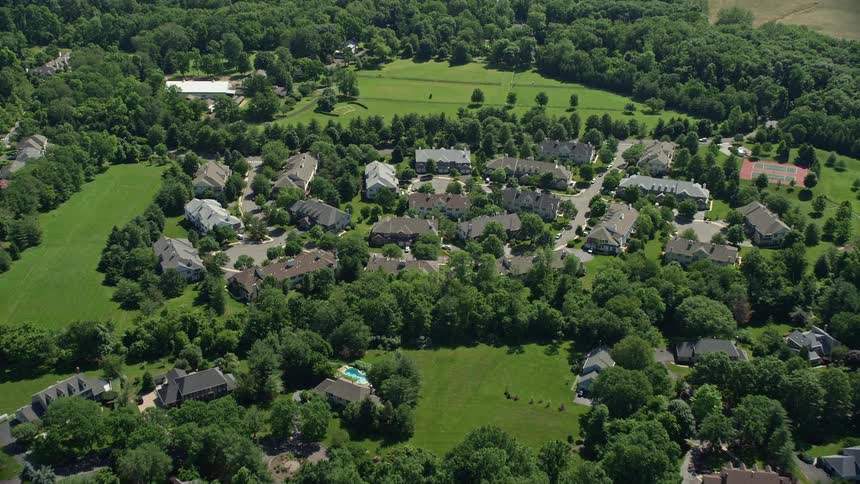 An aerial view of spacious mansions in a Princeton New Jersey neighborhood on a sunny day