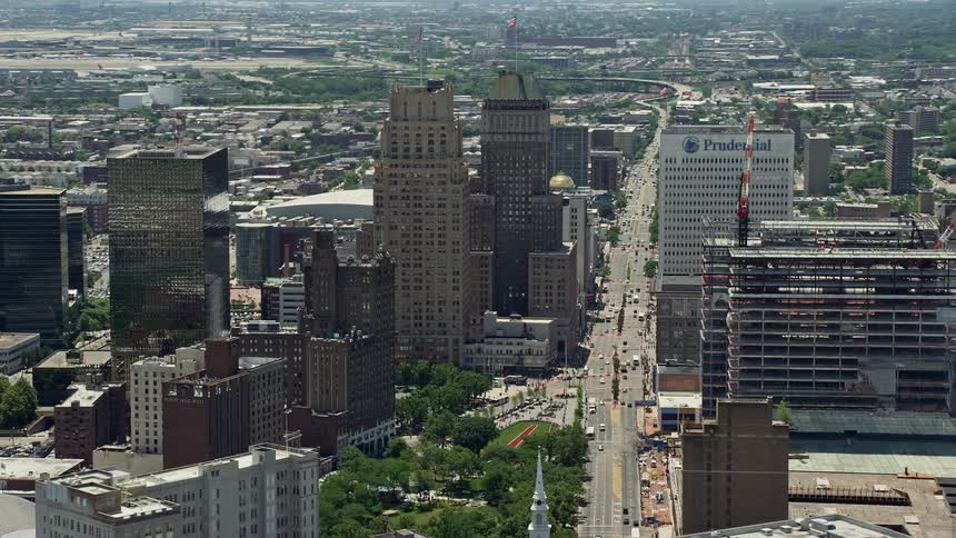 Aerial footage of Downtown Newarks skyscrapers including the under-construction Prudential Tower with cars traveling through the bustling city