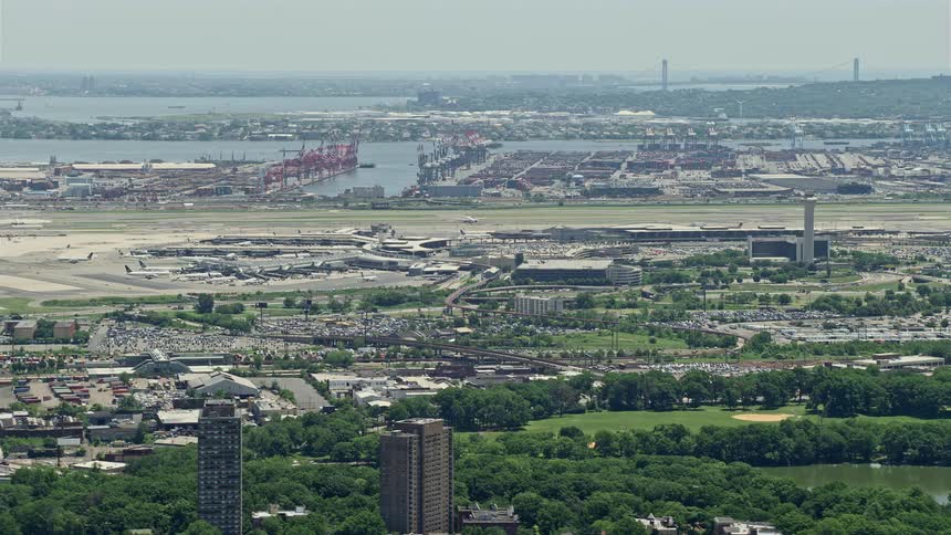 This aerial footage showcases Newark Liberty International Airport and Port Newark New Jersey during a clear summer day revealing the bustling transportation and shipping industry of this East Coast seaport city