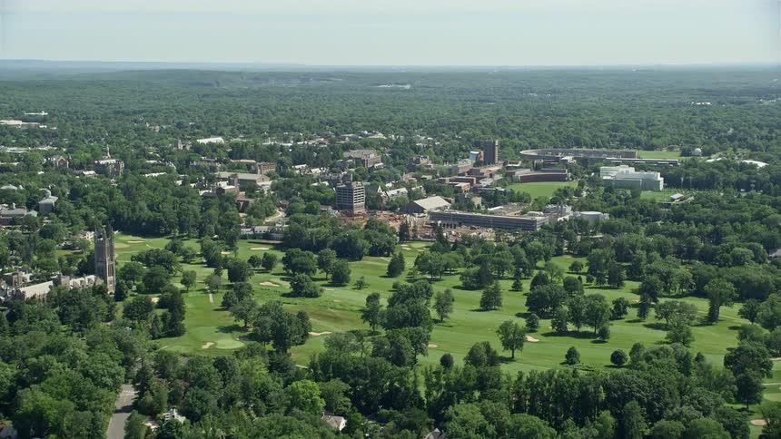 Approaching Princeton University buildings on a sunny day during spring or summer captured in an aerial video footage