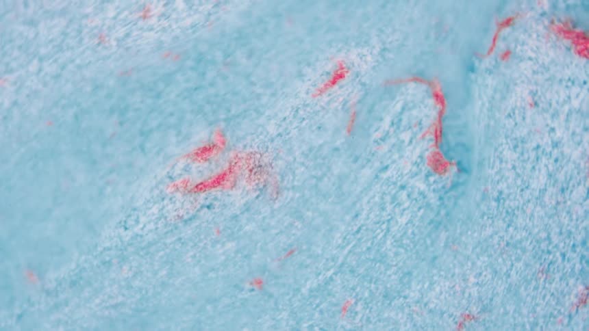 Close up of abstract light blue liquid flowing down