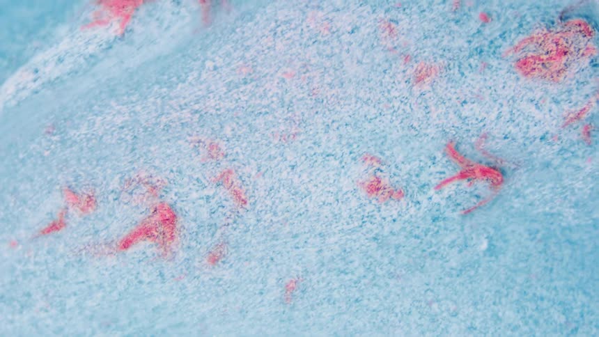 Flowing turquoise and red liquid