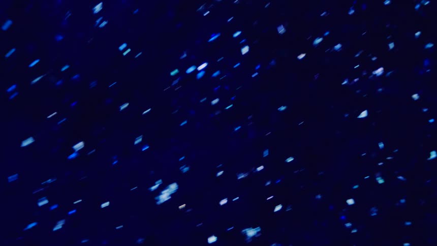 White light specks on a blue background