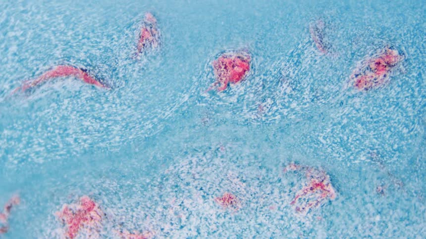 Close up of abstract light blue liquid flowing down