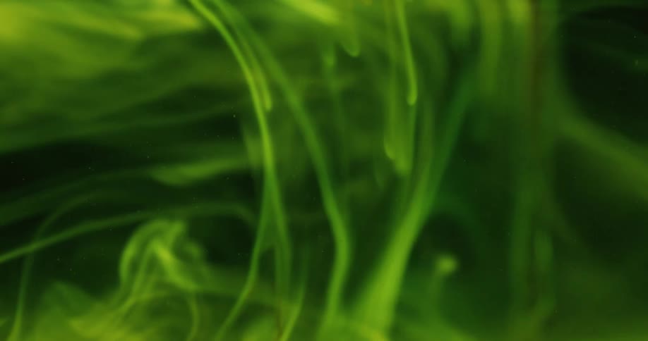 Fluorescent green smoke that takes up the entire space is moving around at different speeds