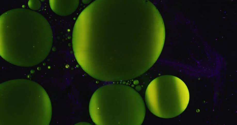 A green ring spreads and explodes into many orbs and become spheres moving together in space