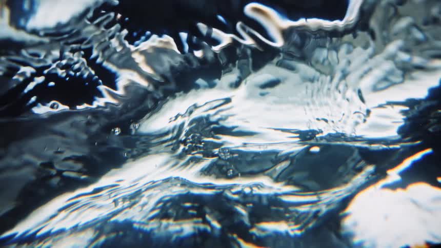 The surface of rippling flowing water