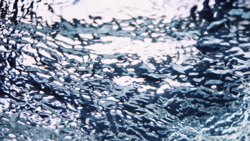 Light reflects on the ripples in the water as it waves and moves