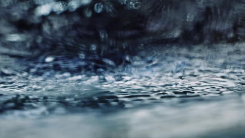 Rain pours into the water