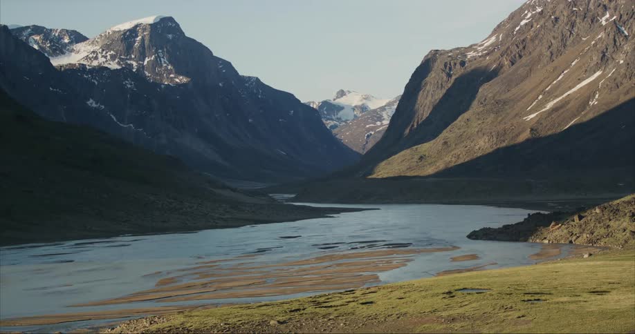 A ice cap and glacier fed river running through a alpine granite valley on Baffin Island