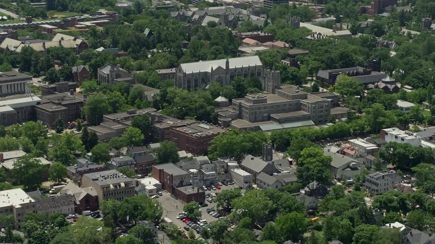 Aerial footage of Princeton University Chapel and the Firestone Library in New Jersey on a sunny day