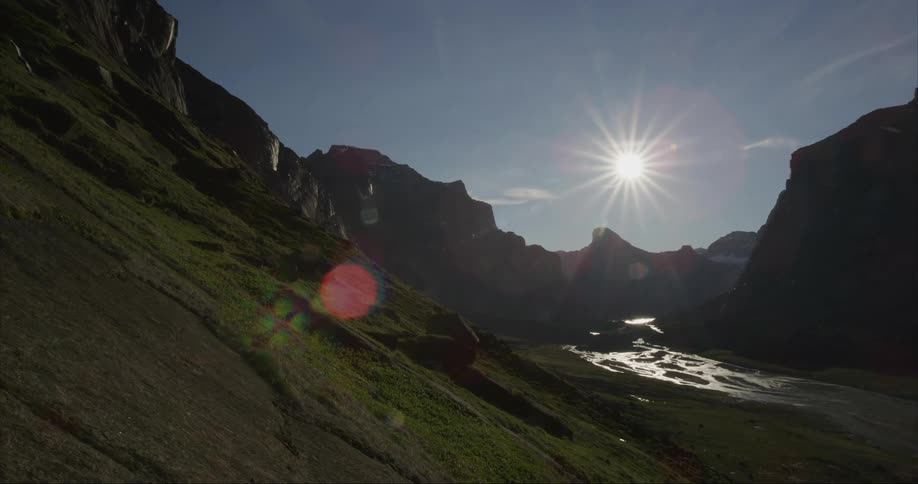 A view of the midnight sun with Mount Thor and the Auyuittuq National Park valley below