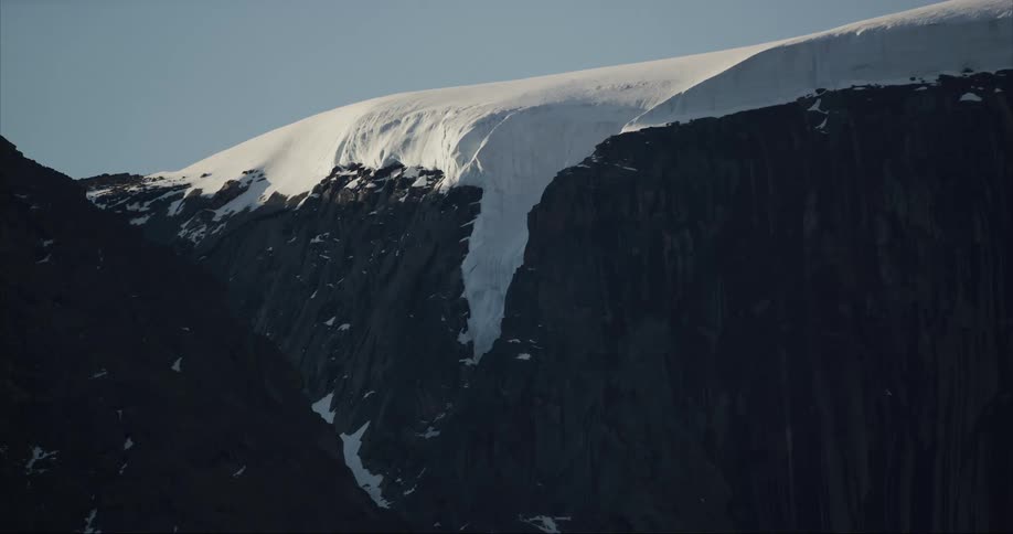 The glacier clings to a mountain where the ice cap ends on Baffin Island