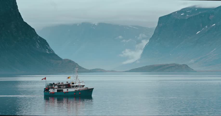 A research boat motoring into port on the Arctic Ocean in Baffin Island