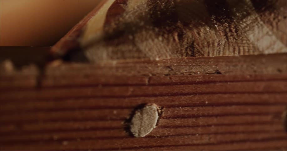A piece of long wood with wood plugs as the camera dolly's along a traditional sea kayak