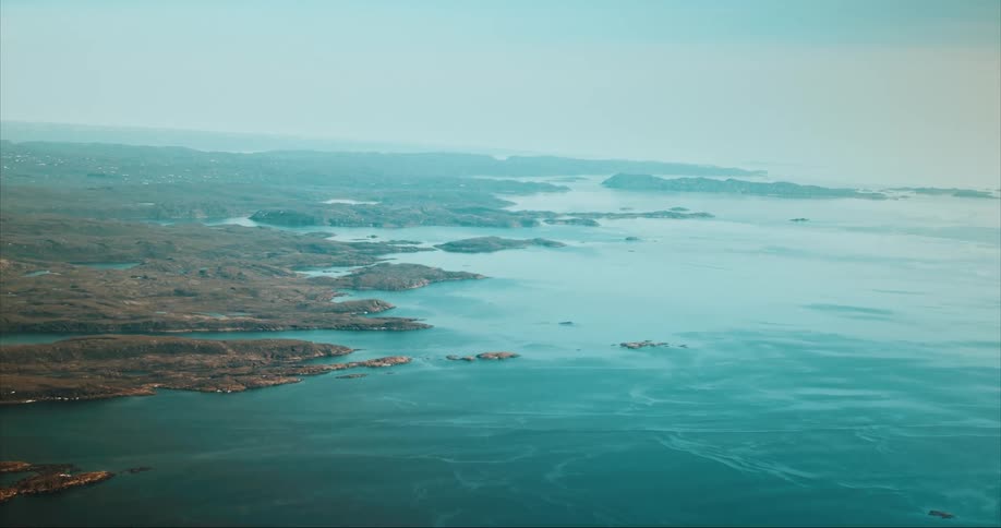 Aerial of the Arctic Ocean and tiny coastal islands of Baffin Island