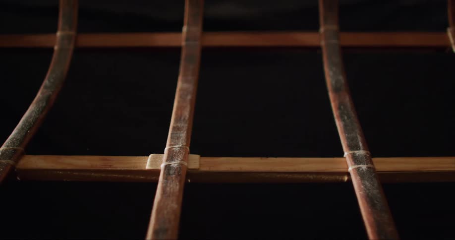 A close up dolly of a wooden frame traditional built sea kayak