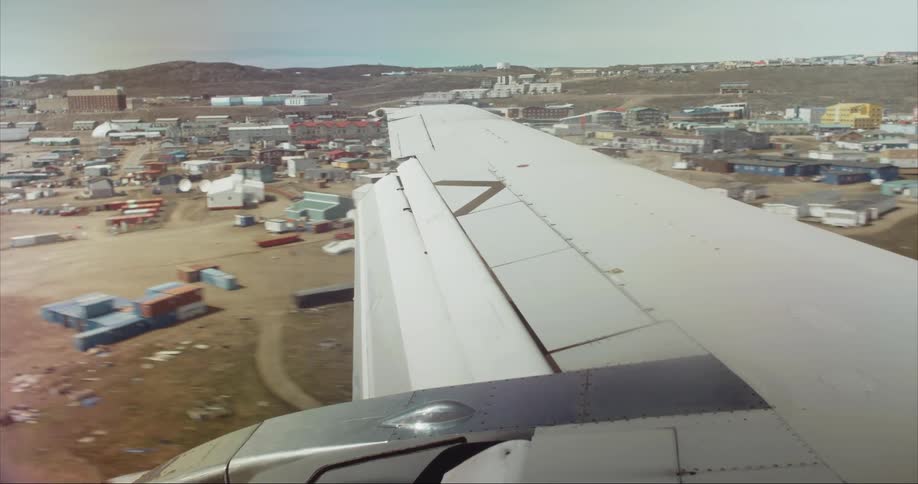 Passenger perspective looking out the window as the airliner touches down in Iqaluit, Baffin Island, Nunavut