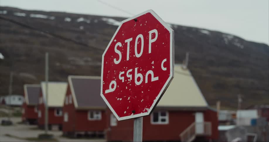 The stop sign is written in Inuit and English on Baffin Island