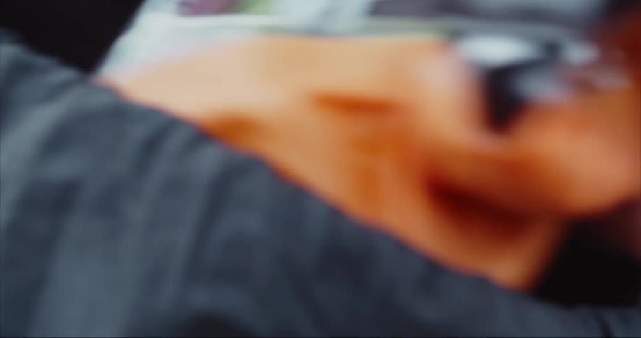 Close up of the hands of a person unpacking a backpack before setting up their tent