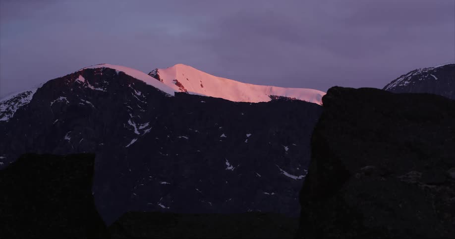 The midnight sun illuminates a glowing glacier in beautiful morning light