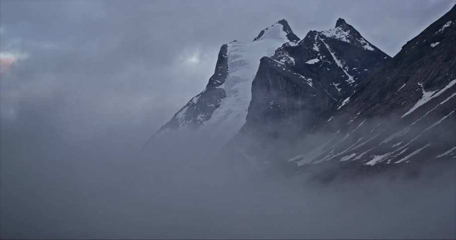 Timelapse of a glacier covered granite mountain on Baffin Island as storm clouds swirl