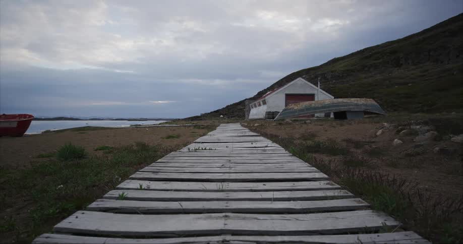 A wooden boardwalk leads the eye into an old Hudson Bay fishing outpost on Baffin Island