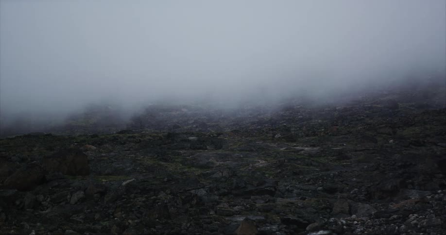Fog rolls over a rocky terrain in this ominous moment in the arctic circle
