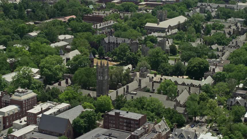 Aerial footage of Princeton Universitys Rockefeller and Mathey Colleges on a sunny day in New Jersey