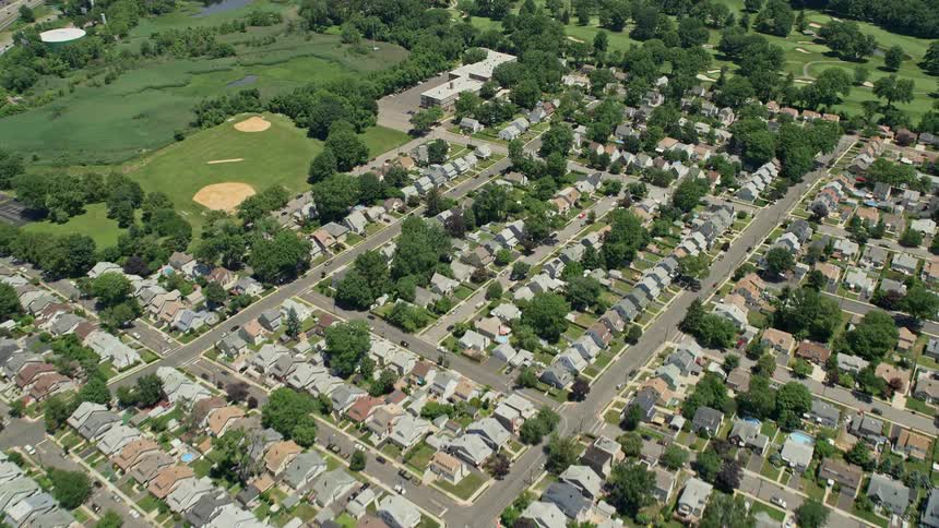 Aerial view of a sunny day flying over a suburban community with a golf course in Union New Jersey