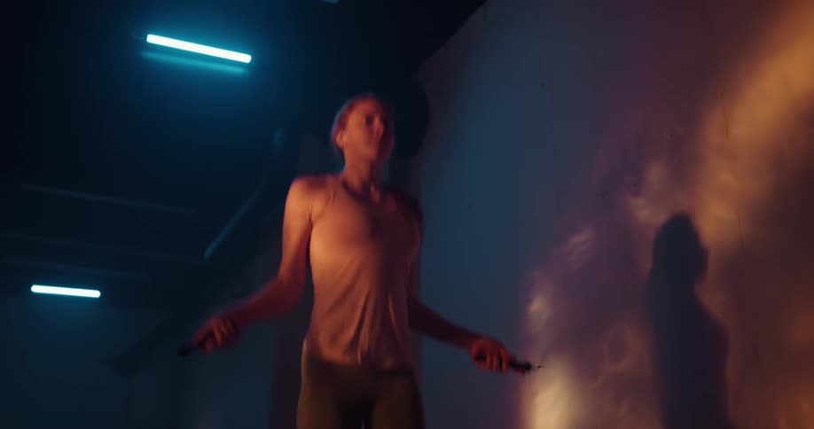 A woman jumps rope in the gym