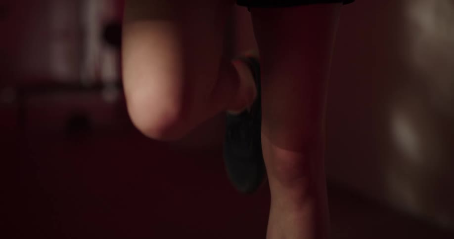 A man is stretching his leg and rubbing his knee with his hand
