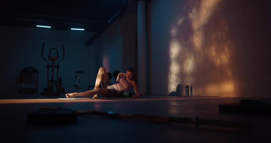 A woman is stretching and doing yoga indoors