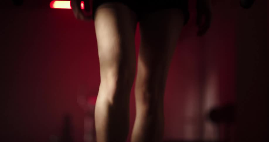 A person is walking on a treadmill inside of a gym
